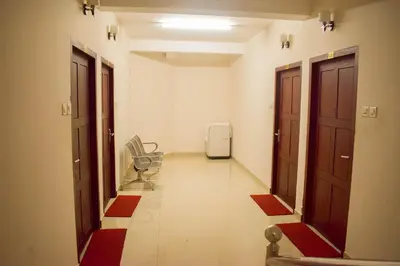 an empty hallway with a room with a radiator and a refrigerator at Ruby Residency in Kozhikode