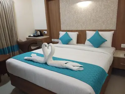 two swansrendered to look like birds sitting on a bed at Hotel iStay in Coimbatore