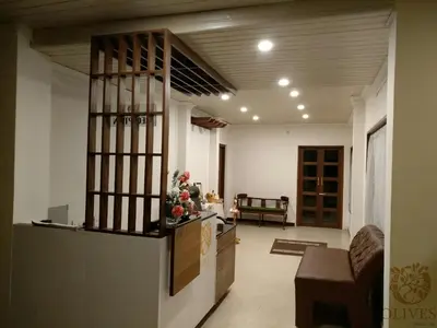 a living room with a kitchen and a lobby at Olives Pleasant Stays in Ooty