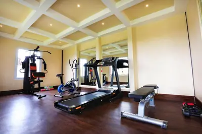 a gym with several exercise equipment in a room at 7 BHK Luxury Heritage Villa - Rock Ooty in Ooty