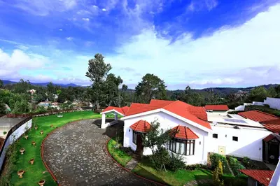 an overhead view of a white house with red roof at 7 BHK Luxury Heritage Villa - Rock Ooty in Ooty