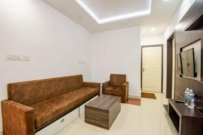 a living room with a couch and a chair at Daan Ambalath Maple Leaves in Guruvāyūr