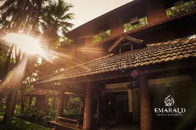 a house with the sun shining on the roof at Emarald Resort in Pulamanthole