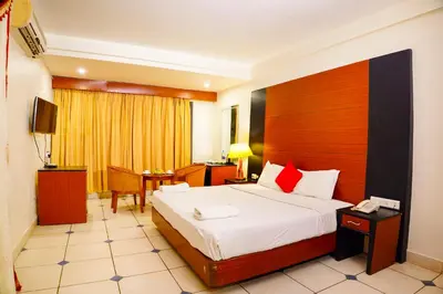 a hotel room with a bed and a desk at Emarald Resort in Pulamanthole