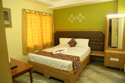 a bedroom with a bed in a room at Hotel Vijay in Pollāchi