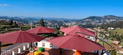 a group of red umbrellas on top of a balcony at Sunset Valley Holiday Inn in Ooty