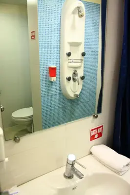 a bathroom with a sink and a mirror at Ginger Tirupur in Tiruppūr