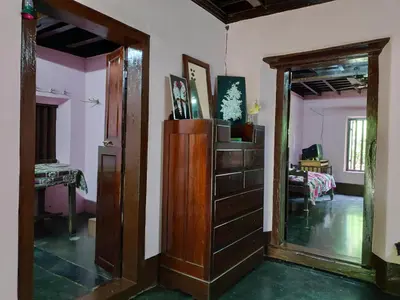 a living room with a mirror and a dresser at Meadows in Trichūr