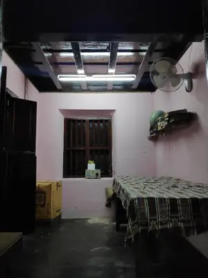 a room with a bed and a window at Meadows in Trichūr