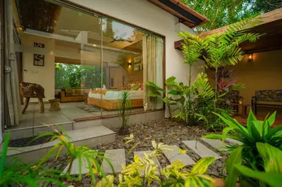 a house with a room with a bed in it at Le Candles Resort in Kozhikode