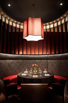 a dining room with a table and a chandelier at Vivanta Coimbatore in Coimbatore