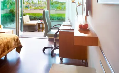 a bedroom with a desk and a chair and a desk at Vivanta Coimbatore in Coimbatore