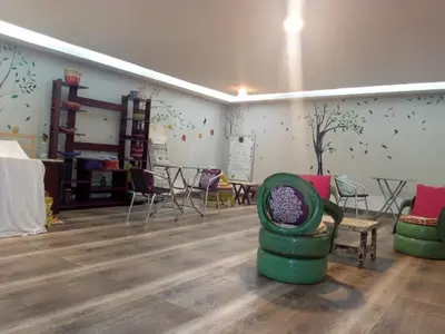 a room with chairs and tables in a room at Hotel Preethi Classic Towers in Ooty