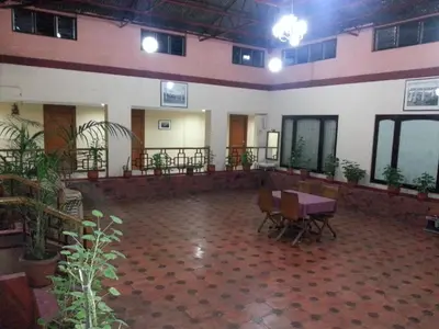 a large room with a table and some plants at Hotel Preethi Classic Towers in Ooty