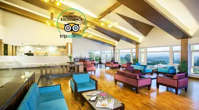 a lobby of a hotel with colorful furniture and windows at Sterling Ooty Elk Hill in Ooty