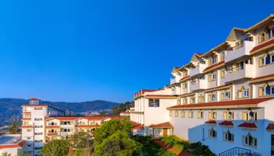 a group of buildings on top of a hill at Sterling Ooty Elk Hill in Ooty