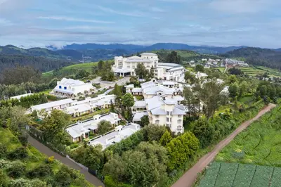 an aerial view of a large white house at Sterling Ooty Fern Hill in Ooty