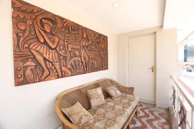 a couch in a room with a painting on the wall at Hotel Silver Oak in Ooty