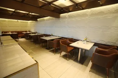 a restaurant with tables and chairs in a room at Delightz Inn in Ooty