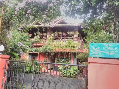 a building with a bunch of plants on it at The Four Seasons in Kalpetta