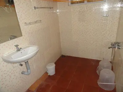 a bathroom with a sink and a toilet at The Four Seasons in Kalpetta