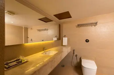 a bathroom with a sink and a toilet at Grand Plaza Suites in Kozhikode