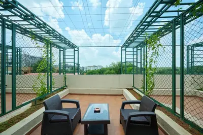 a room with chairs and a table on a roof at Flora Airport Hotel and Convention Centre Kochi in Nedumbassery