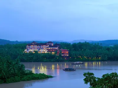 a view of a river with buildings in the distance at The Raviz Kadavu, Kozhikode in Kozhikode