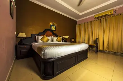 a bedroom with a large bed in a room at Kallada Regency in Irinjālakuda