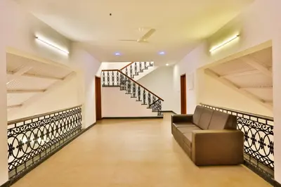 a living room with a staircase in a house at Mystique stay resort in Kotagiri