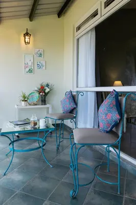 two chairs and a table on a patio at King's Cliff in Ooty