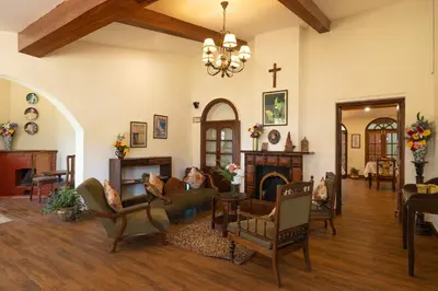 a living room filled with furniture and a fireplace at Sherlock in Ooty
