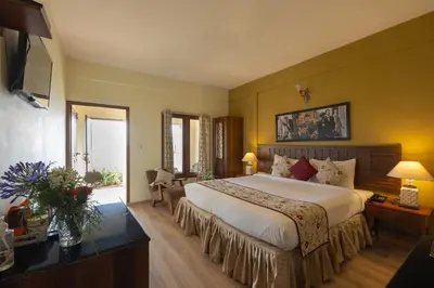 a hotel room with a large bed and a window at Sherlock in Ooty