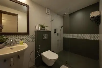 a bathroom with a toilet and a sink and a shower at Sherlock in Ooty