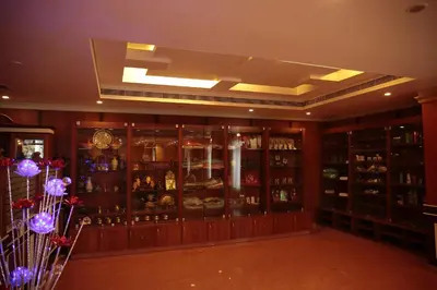 a room with a large display case in a store at Joys Palace Hotel in Trichūr