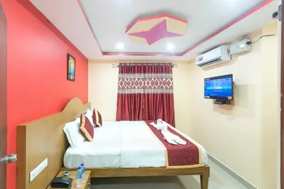 a small room with a bed and a tv at Sree Comforts in Kushālnagar