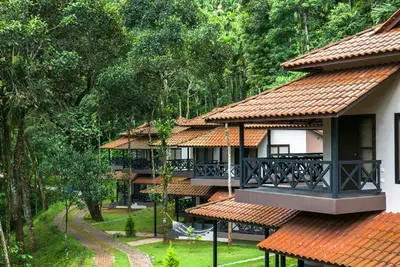 a resort building with a balcony and trees at The Serenity Resort in Tariyod
