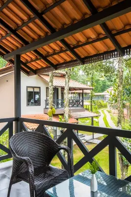 a patio with a wicker chair and a table at The Serenity Resort in Tariyod