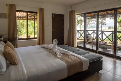 a bedroom with a large bed and a balcony at The Serenity Resort in Tariyod