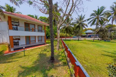 a view of a house with a yard at Kappad Beach Resort in Kappad