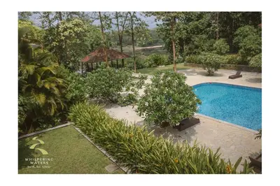 an aerial view of a swimming pool in a garden at Whispering Waters in Malayāttūr