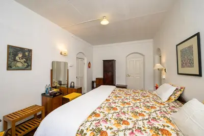 a bedroom with a large bed in a room at Neemrana's Wallwood Garden in Coonoor