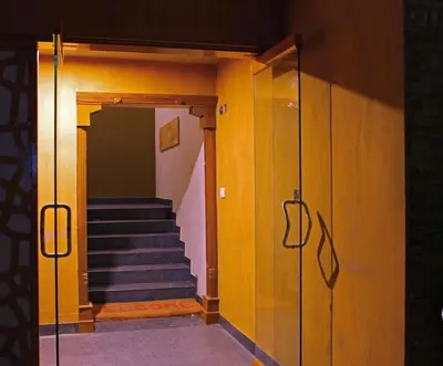 a hallway with stairs in a building with yellow walls at Rathna Square in Pollāchi