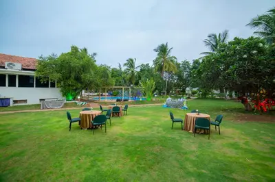 a group of tables and chairs in a yard at Poppys Vista Hotel in Thirumurugan Poondi
