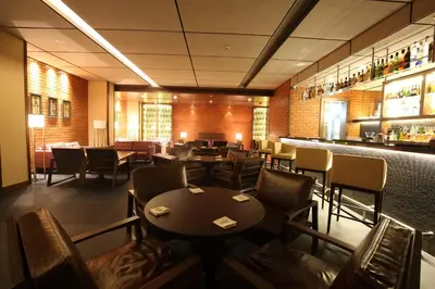 a restaurant with tables and chairs and a bar at The Residency Towers Coimbatore in Coimbatore