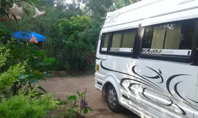 a white van with black writing on the side of it at Dreams Home Estate Stay in Suntikoppa