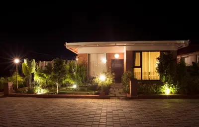 a house at night with lights in front of it at Sixth Element in Kushālnagar