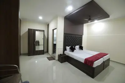 a bedroom with a large bed and a mirror at Shivalaya Residency in Trichūr