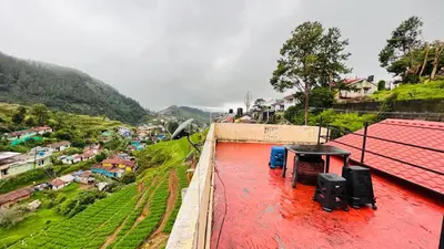 a view of a roof of a building with red water at Mountain View cottage in Ooty