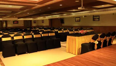 a conference room with black chairs and a table with a bouquet at YASH INTERNATIONAL in Kozhikode